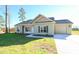 Inviting one-story home featuring a side entry garage and manicured lawn at 404 S Eastwood Dr, Benson, NC 27504