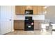Kitchen with black appliances and wooden cabinets with ample storage space at 404 S Eastwood Dr, Benson, NC 27504