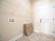 Practical laundry room features tile floor, wall shelving, and washer-dryer hookups at 404 S Eastwood Dr, Benson, NC 27504