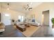 Bright living room featuring a ceiling fan, gray flooring, and neutral walls at 404 S Eastwood Dr, Benson, NC 27504