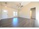 Bright living room featuring wood flooring, ceiling fan, and neutral walls at 404 S Eastwood Dr, Benson, NC 27504