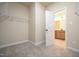 Carpeted walk-in closet leading to the bathroom at 404 S Eastwood Dr, Benson, NC 27504