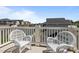 Balcony featuring white wicker chairs with views of the surrounding neighborhood at 43 Quarter Gate Trce, Chapel Hill, NC 27516