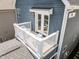 Exterior angled view of a balcony with white railings and furniture and doors to the bedroom at 43 Quarter Gate Trce, Chapel Hill, NC 27516