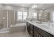 Bathroom featuring a soaking tub, glass shower, tile flooring, and double sinks at 43 Quarter Gate Trce, Chapel Hill, NC 27516