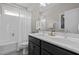 Bathroom with double sink vanity, granite countertops and shower-tub combination with white tile and curtain at 43 Quarter Gate Trce, Chapel Hill, NC 27516