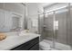 Modern bathroom featuring marble countertops, vanity sink, and glass-enclosed shower with gray tiling at 43 Quarter Gate Trce, Chapel Hill, NC 27516