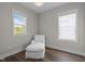 Bright bedroom featuring hardwood floors and comfortable white lounge seating by two windows at 43 Quarter Gate Trce, Chapel Hill, NC 27516