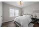 Neutral toned bedroom featuring a queen-sized bed, a modern chandelier, and a large mirror at 43 Quarter Gate Trce, Chapel Hill, NC 27516