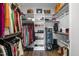 Walk-in closet features custom shelving, drawers, hanging rods and space for shoes and accessories at 43 Quarter Gate Trce, Chapel Hill, NC 27516