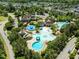 Stunning aerial view of the community pool area with a slide, splashpad, and neighborhood in the background at 43 Quarter Gate Trce, Chapel Hill, NC 27516