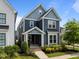 Beautiful two-story house with a landscaped front yard, covered porch and blue siding at 43 Quarter Gate Trce, Chapel Hill, NC 27516