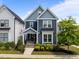 Charming two-story blue house with manicured landscaping and a welcoming front porch at 43 Quarter Gate Trce, Chapel Hill, NC 27516
