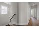 Hallway with wooden floors, staircase, bright window and doors to other rooms of the house at 43 Quarter Gate Trce, Chapel Hill, NC 27516