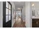 Inviting hallway featuring a dark front door, light walls, wood floors and sliding barn door at 43 Quarter Gate Trce, Chapel Hill, NC 27516