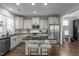 Well-lit kitchen featuring stainless steel appliances, a kitchen island with seating and dark granite countertops at 43 Quarter Gate Trce, Chapel Hill, NC 27516
