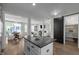 Open concept kitchen with a kitchen island that has seating, stainless steel appliances and a black countertop at 43 Quarter Gate Trce, Chapel Hill, NC 27516