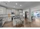 Spacious kitchen with white cabinets, stainless steel appliances, island with seating, and an open floor plan at 43 Quarter Gate Trce, Chapel Hill, NC 27516