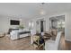 Inviting living room with hardwood floors, a large TV, a dining table and bright lighting at 43 Quarter Gate Trce, Chapel Hill, NC 27516