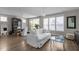 Bright living room featuring a white sofa, wood floors, and view of dining area, creating an inviting space at 43 Quarter Gate Trce, Chapel Hill, NC 27516
