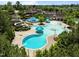 Aerial view of a vibrant community pool area, featuring multiple pools, water slides, and green spaces at 43 Quarter Gate Trce, Chapel Hill, NC 27516