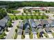 Charming street view showcases well-maintained homes, green lawns, and a school in the background at 43 Quarter Gate Trce, Chapel Hill, NC 27516