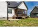 View of the backyard with a screened in porch and gas grill at 474 Pine Ridge Rd, Zebulon, NC 27597