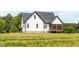 Side of home with black roof and screened in back porch at 474 Pine Ridge Rd, Zebulon, NC 27597