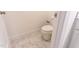 Toilet area with marble style tile flooring and white walls at 474 Pine Ridge Rd, Zebulon, NC 27597