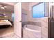 Bathroom with a tub featuring tile surround and a view into a bedroom at 474 Pine Ridge Rd, Zebulon, NC 27597