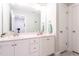 Well-lit bathroom with a double sink vanity featuring white cabinets and decorative tile flooring at 474 Pine Ridge Rd, Zebulon, NC 27597