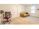 Spacious carpeted room with a futon, desk, and chair provides flexible living space at 474 Pine Ridge Rd, Zebulon, NC 27597