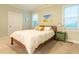 Cozy bedroom with carpet flooring, wood bed frame, and plenty of natural light from the windows at 474 Pine Ridge Rd, Zebulon, NC 27597