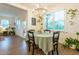 This dining room features a table, chandelier, and is filled with natural light at 474 Pine Ridge Rd, Zebulon, NC 27597
