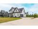 Attractive two-story home with a driveway leading to an attached two-car garage at 474 Pine Ridge Rd, Zebulon, NC 27597