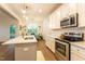 This kitchen features stainless steel appliances, white cabinets, and an island with bar seating at 474 Pine Ridge Rd, Zebulon, NC 27597