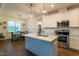 A kitchen features stainless steel appliances, a center island, and pendant lighting at 474 Pine Ridge Rd, Zebulon, NC 27597