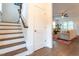 Staircase leading into a cozy living room with a comfortable sofa and an area rug at 474 Pine Ridge Rd, Zebulon, NC 27597