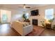 Bright living room features a fireplace, ceiling fan and light colored walls at 474 Pine Ridge Rd, Zebulon, NC 27597