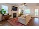 Bright living room featuring a fireplace, large windows, and a comfortable seating area at 474 Pine Ridge Rd, Zebulon, NC 27597