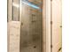 Close up of glass shower and tile with a tiled niche and marble floor at 474 Pine Ridge Rd, Zebulon, NC 27597