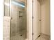 Luxurious glass enclosed shower with marble style tile and tiled niche at 474 Pine Ridge Rd, Zebulon, NC 27597