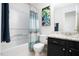 Bathroom featuring a bathtub, framed art and dark vanity at 504 High Ridge Dr, Durham, NC 27707