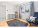 Bedroom area featuring hardwood floors, a blue chair and an organizer at 504 High Ridge Dr, Durham, NC 27707