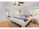 Bright bedroom with hardwood floors, ceiling fan, large mirror, and comfortable queen bed at 504 High Ridge Dr, Durham, NC 27707