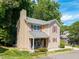 Charming two-story home features red shutters, a chimney, and a cozy front porch seating area at 504 High Ridge Dr, Durham, NC 27707