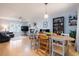 Open-concept living and dining area with a fireplace, hardwood floors, and plenty of natural light at 504 High Ridge Dr, Durham, NC 27707