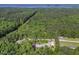 Aerial shot of the property showing the acreage and wooded neighborhood at 506 Burgess Rd, Apex, NC 27523