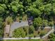 An aerial view of the property, showcasing the house, outbuildings and acreage of the lot at 506 Burgess Rd, Apex, NC 27523