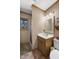 Bathroom featuring a vanity with wood accents, a shower and a window at 506 Burgess Rd, Apex, NC 27523